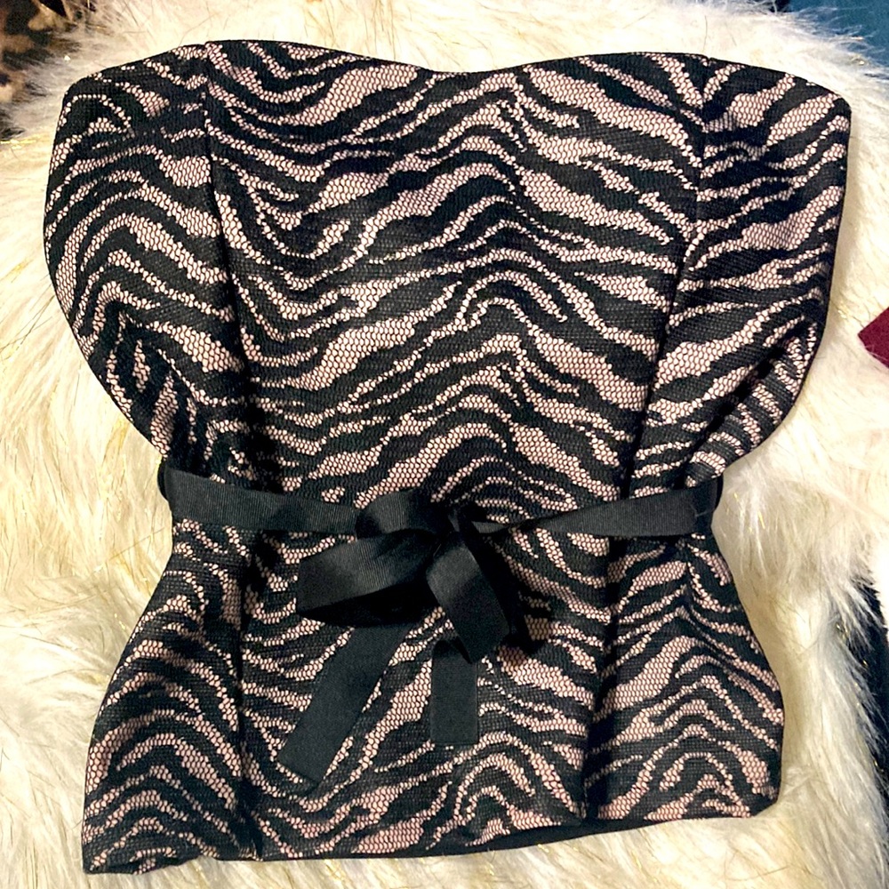 A black and pink laced strapless top with a string tied in a bow or as you wish
